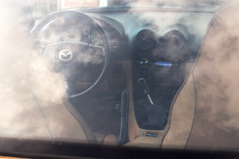 The Miata is in first gear here. The combination of short shifter + extended shifter results in throws slightly shorter than stock, with the knob ~4" closer to the steering wheel.